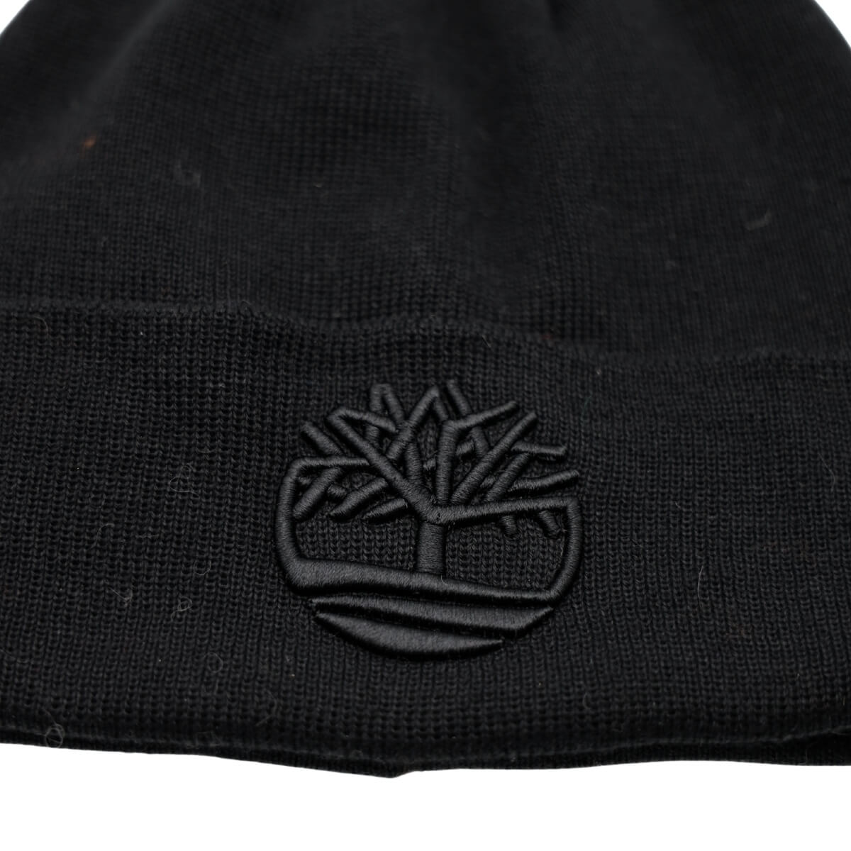 Accessorio invernale Timberland blu con logo ricamato.